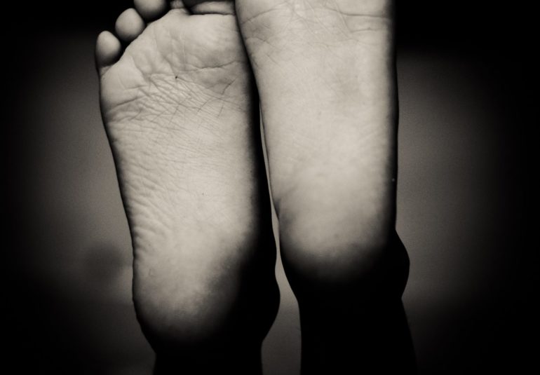 grayscale photo of human feet