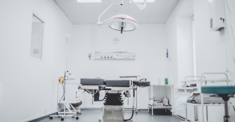 black and white hospital bed in the middle of interior building