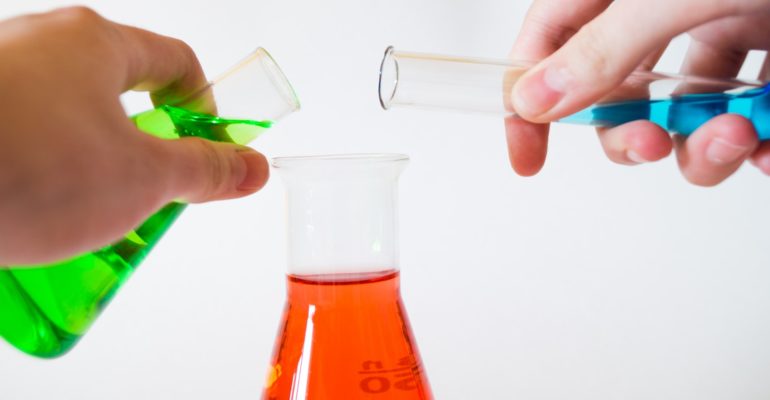 person holding laboratory flasks