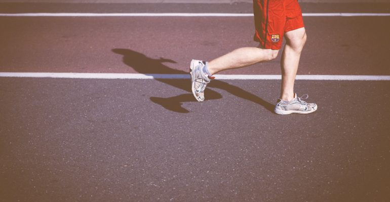 person running on concrete road