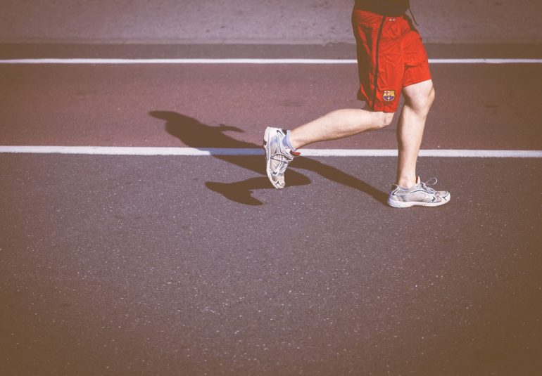 person running on concrete road